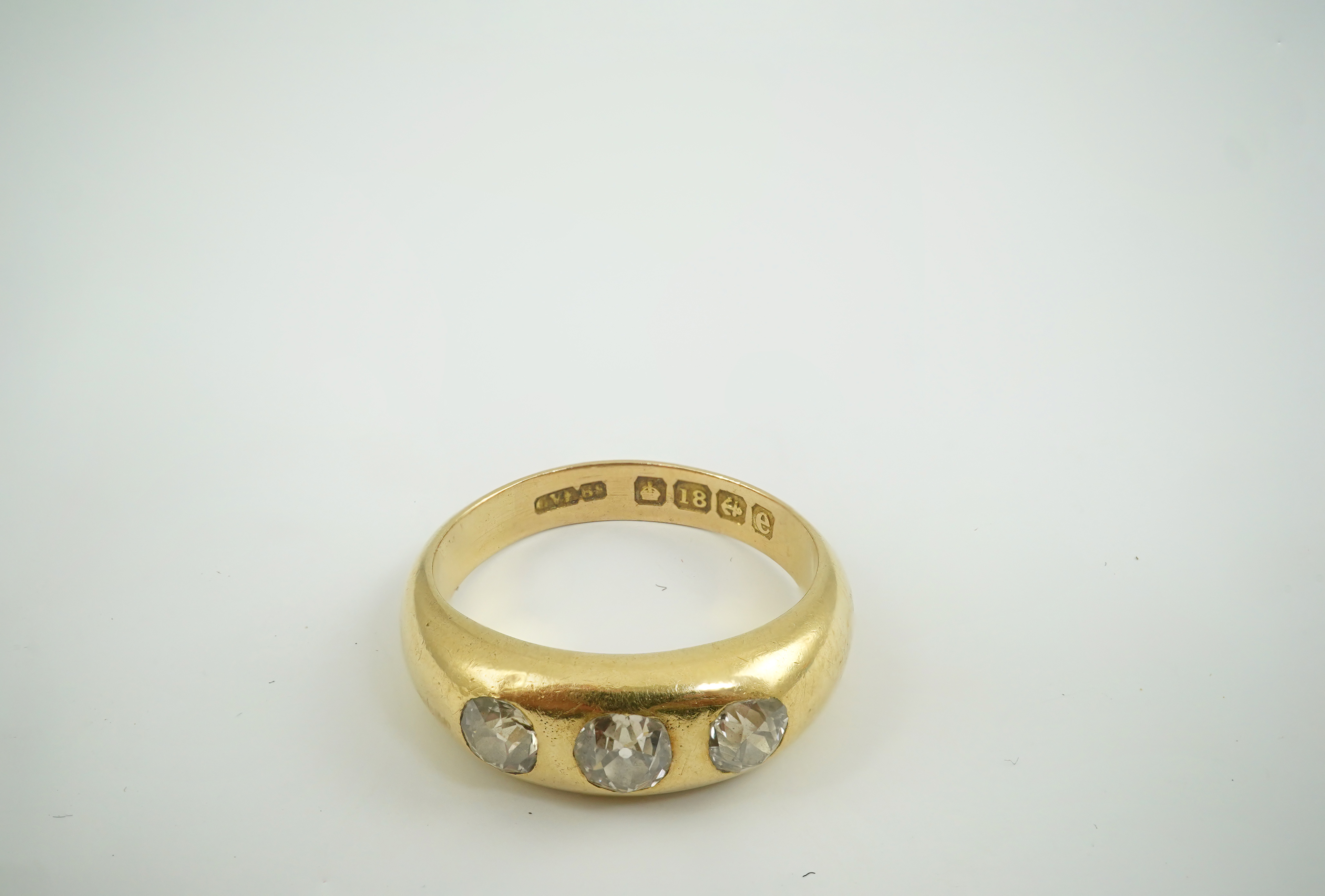 An Edwardian 18ct gold and gypsy set three stone diamond ring